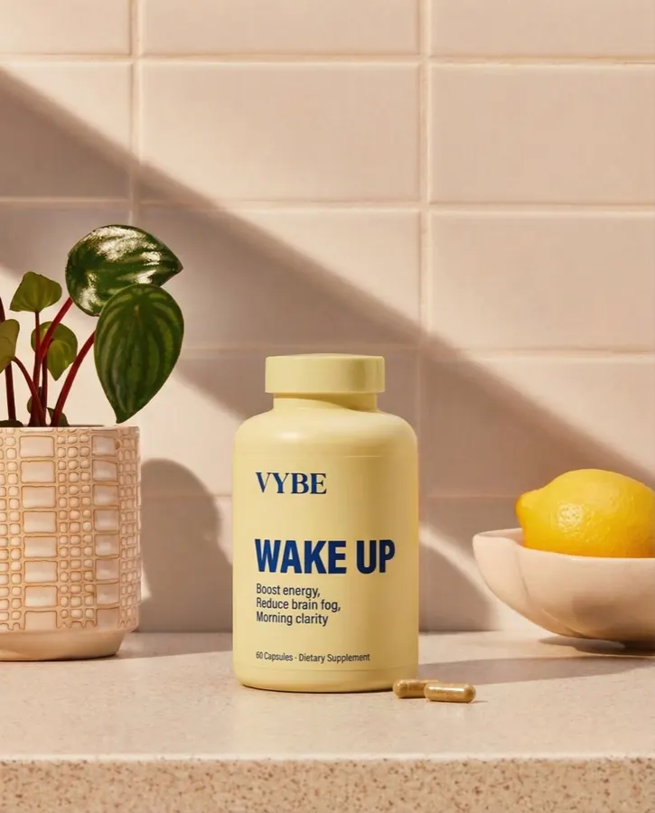 Supplement bottle on a kitchen bench with fresh lemons